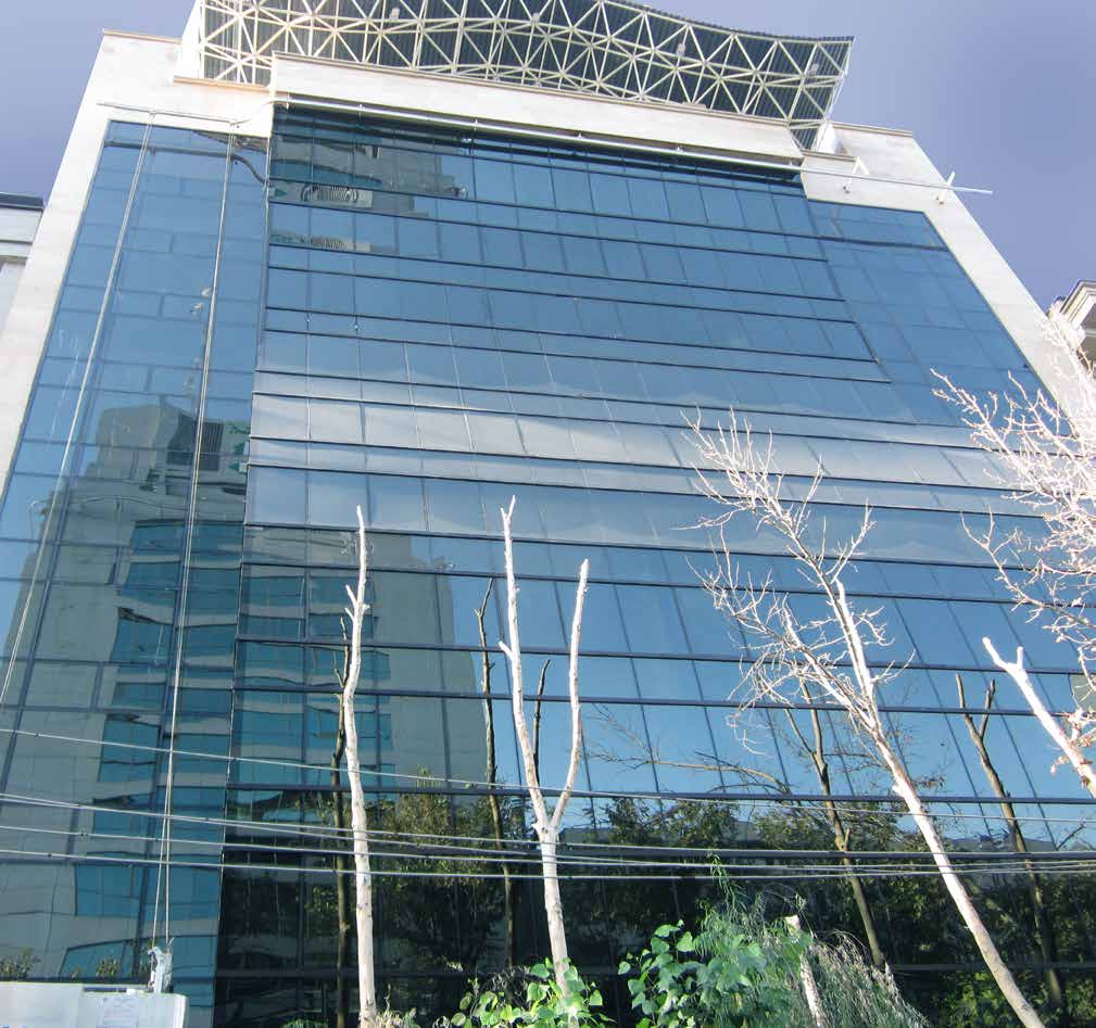 Glass curtain wall tower against a clear sky